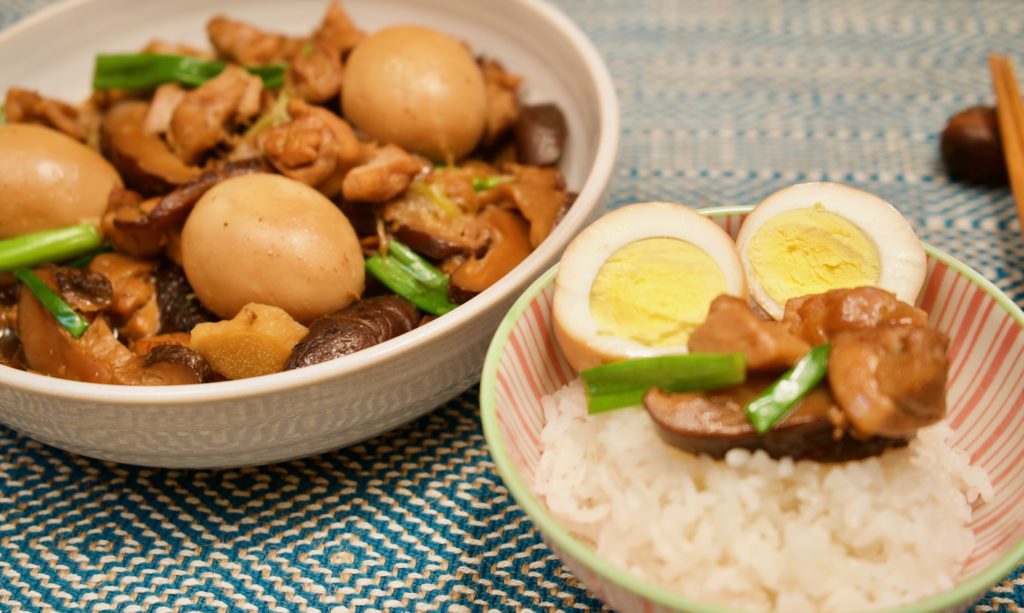 bowl of chinese braised chicken with eggs and mushrooms and rice bowl