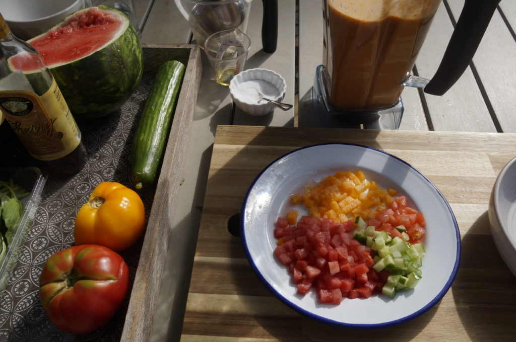 Diced watermelon, cucumber and tomatoes make nice toppings for a bowl of refreshing watermelon gazpacho.