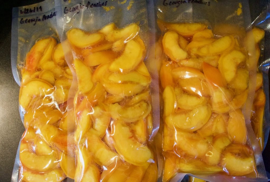 Bagged and sealed peach slices, for freezing.