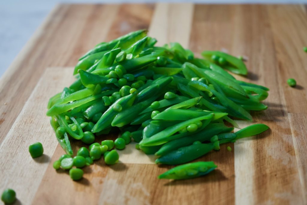 Blanched and sliced snap peas.