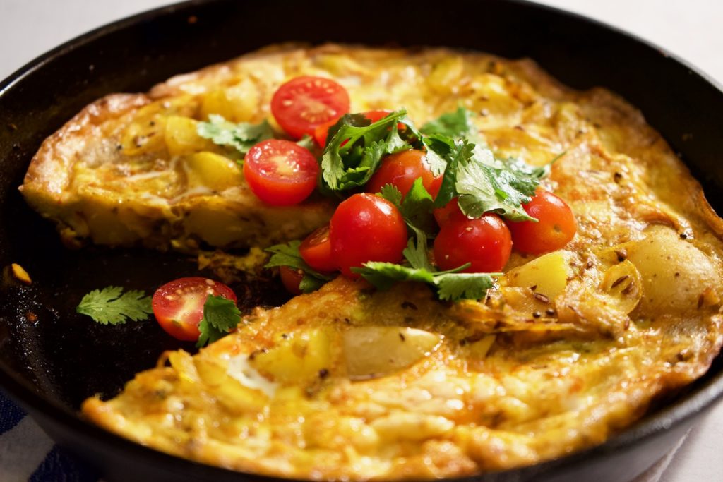 A potato frittata spiced with whole cumin, coriander and mustard seeds. Tender potatoes and sweet onions make this a delicious egg dish for any time of day or night!