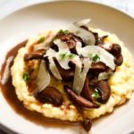 A red wine mushroom ragout on top of creamy, goat cheese polenta. Garnished with shaved parmesan and thyme leaves.