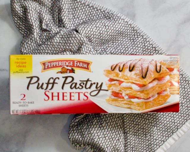 Box of puff pastry on towel.