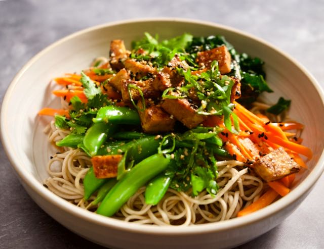 Soba noodle bowls with raw vegetables and tofu.