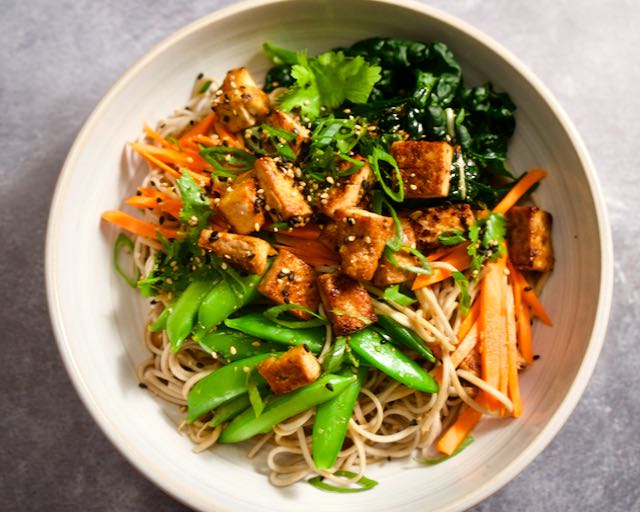 Soba noodle bowls with tofu and vegetables.