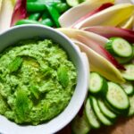 Green pea dip with platter of vegetables.