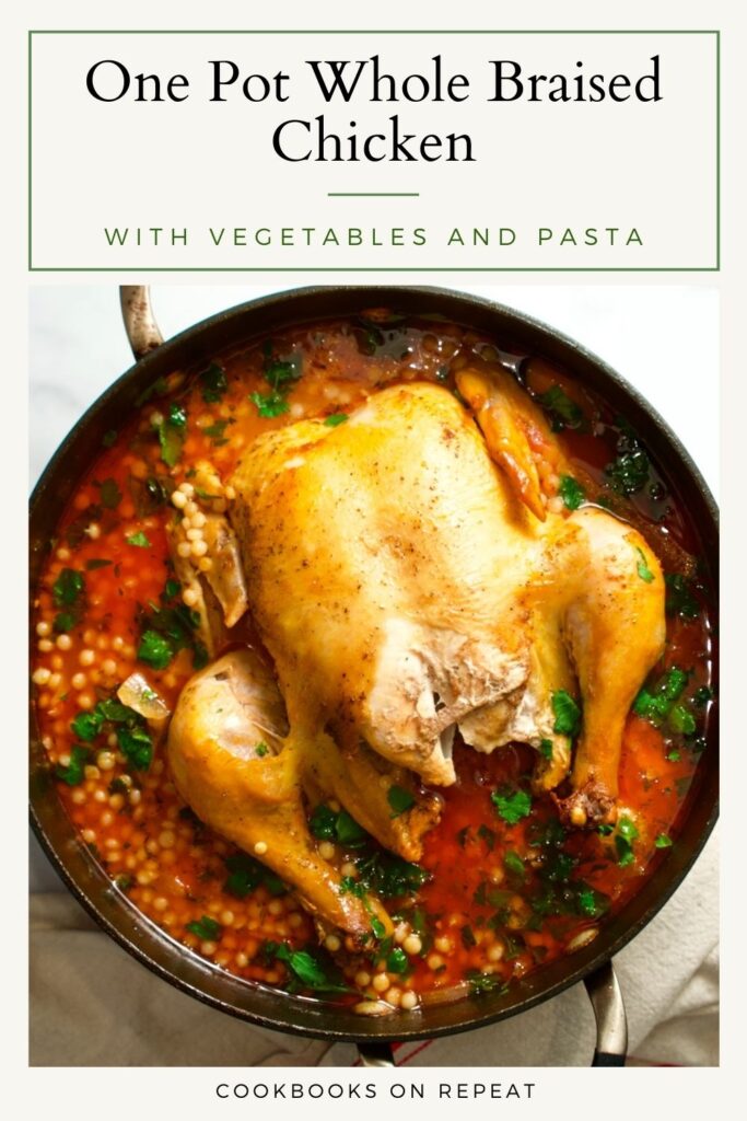 Whole chicken in a pot with pasta and  vegetables.