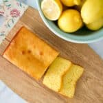 Pound cake on board with bowl of lemons.