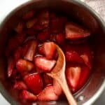 Strawberries cooking in small saucepan.